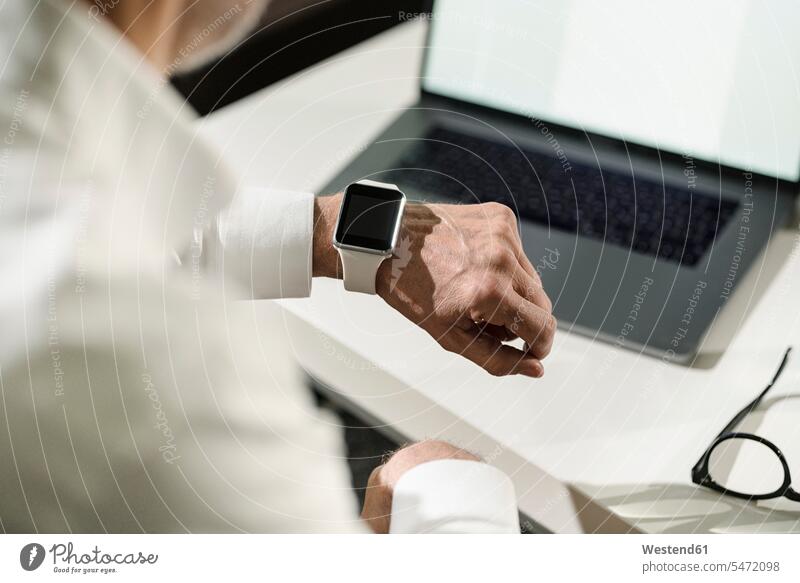 Close-up of senior man's hand with smartwatch and laptop human human being human beings humans person persons caucasian appearance caucasian ethnicity european
