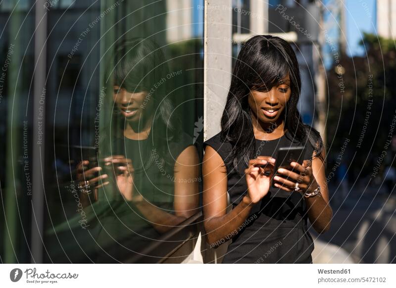 Businesswoman using smartphone in the city human human being human beings humans person persons African black black ethnicity coloured African American