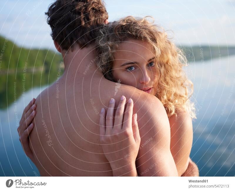 Nude couple embracing in nature, woman looking at camera embrace Embracement hug hugging seasons spring season Spring Time springtime happy Emotions Feeling