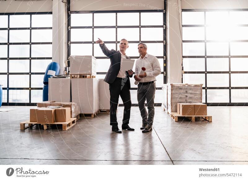 Two businessmen talking in a factory human human being human beings humans person persons caucasian appearance caucasian ethnicity european 2 2 people 2 persons