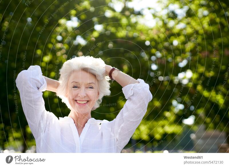 Portrait of happy mature woman in nature human human being human beings humans person persons celibate celibates singles solitary people solitary person relax
