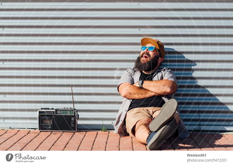 Portrait of bearded man with portable radio enjoying sunlight human human being human beings humans person persons caucasian appearance caucasian ethnicity