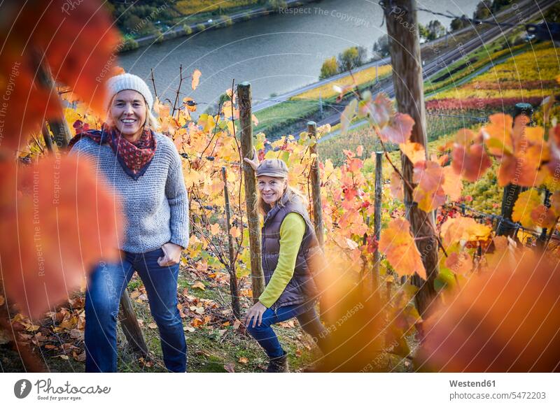 Portrait of two mature woman in a vineyard friends mate female friend caps hat hats smile seasons fall relax relaxing relaxation delight enjoyment Pleasant