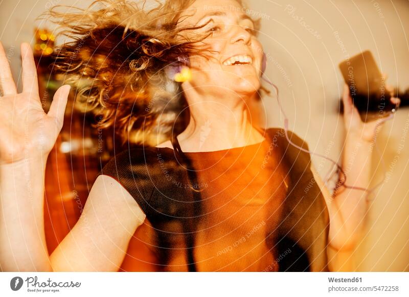 Close-up of cheerful woman dancing while listening music at home color image colour image Germany leisure activity leisure activities free time leisure time