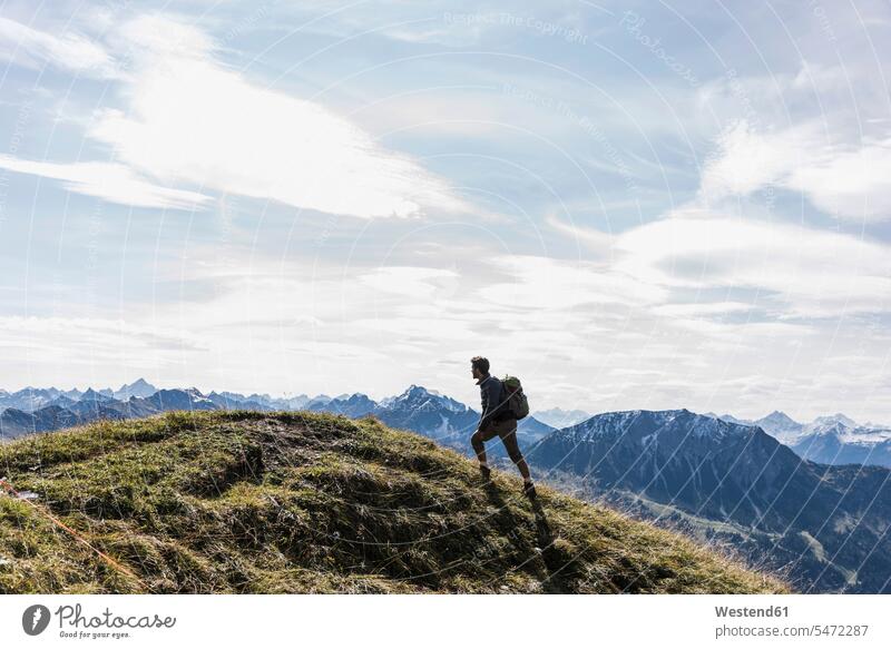 Austria, Tyrol, young man hiking in the mountains mountain range mountain ranges men males hike mountainscape mountainscapes mountain scenery Mountainous Region