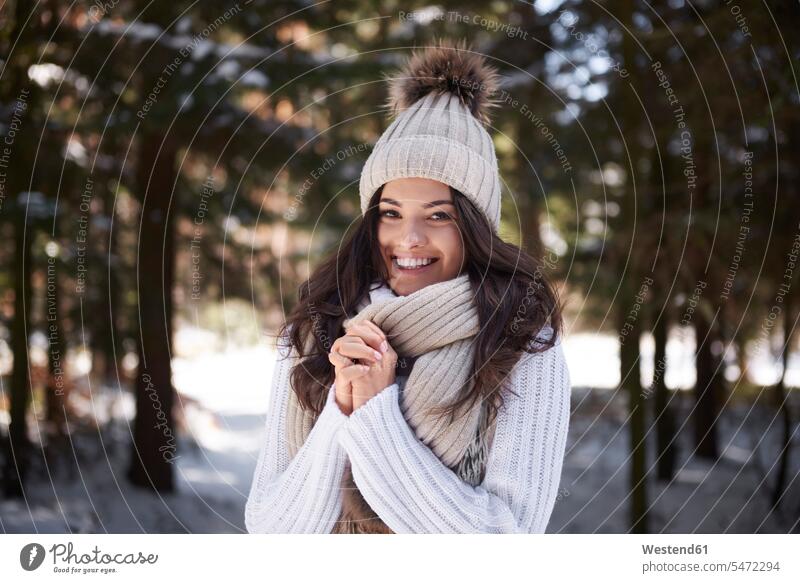 Portrait of happy young woman wearing knitwear in winter forest happiness woods forests hibernal females women portrait portraits Adults grown-ups grownups