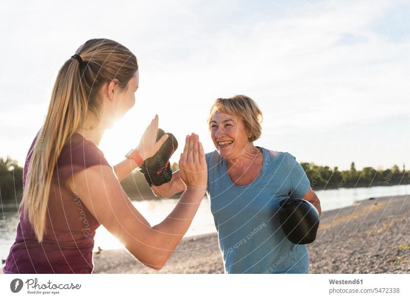 Grandmother doing boxing training with her graddaughter at the river fitness granddaughter granddaughters grandmother grandmas grandmothers granny grannies