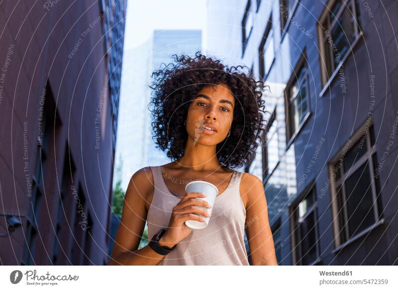 Germany, Frankfurt, portrait of young woman with coffee to go in the city portraits Coffee town cities towns females women Drink beverages Drinks Beverage