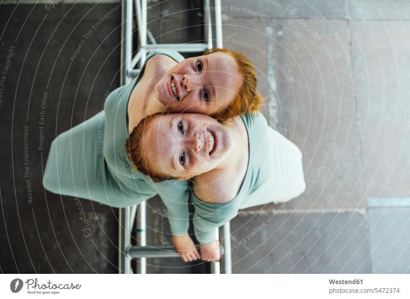 Redheaded twins woman females women redheaded red hair red hairs red-haired Reclining sister sisters equality Adults grown-ups grownups adult people persons