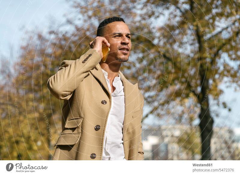 Portrait of businessman on the phone in autumn business life business world business person businesspeople Business man Business men Businessmen business attire