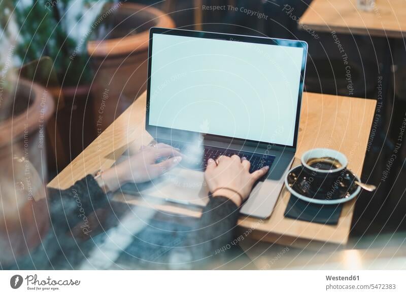 Close-up of woman using laptop on table in a cafe human human being human beings humans person persons caucasian appearance caucasian ethnicity european