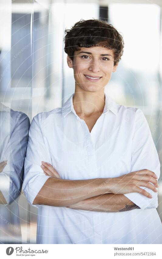 Portrait of smiling businesswoman in office offices office room office rooms portrait portraits smile businesswomen business woman business women workplace