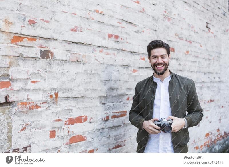 Portrait of laughing young man with camera human human being human beings humans person persons dark-haired brown haired brown-haired brunette Mixed Race