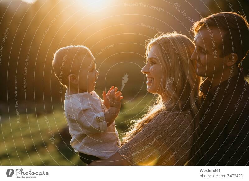 Happy family with little son outdoors at sunset human human being human beings humans person persons caucasian appearance caucasian ethnicity european Group