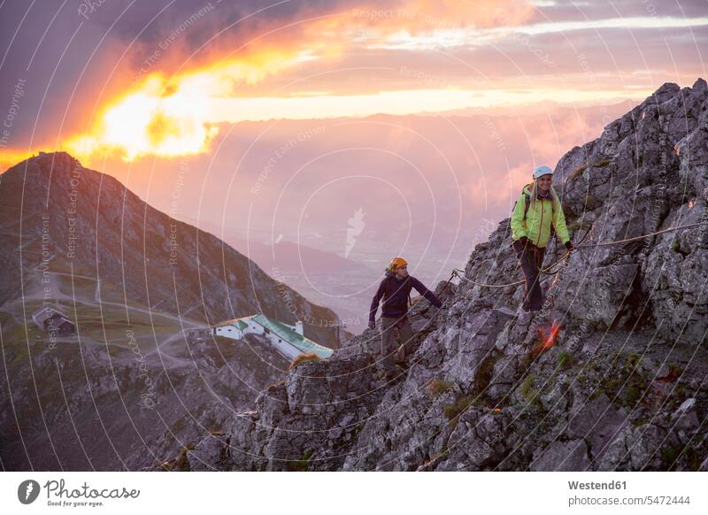 Austria, Tyrol, Innsbruck, mountaineer at Nordkette via ferrata at sunrise rock climbing Adventure adventurous Adventures alpinism sport sports climber