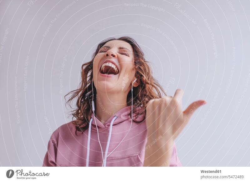 Brunette woman listening to music and singing human human being human beings humans person persons caucasian appearance caucasian ethnicity european 1