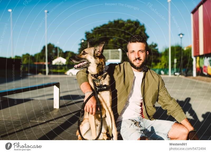 Portrait of young man with his dog dogs Canine men males portrait portraits pets animal creatures animals Adults grown-ups grownups adult people persons
