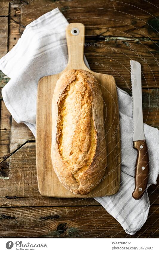 Ciabatta on wooden board nobody kitchen towel Bread Knife vertical vertically delicacy specialty specialties White Bread White Breads wheat bread Italian Food