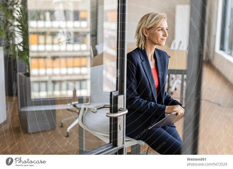 Blond businesswoman holding tablet in conference room Occupation Work job jobs profession professional occupation business life business world business person