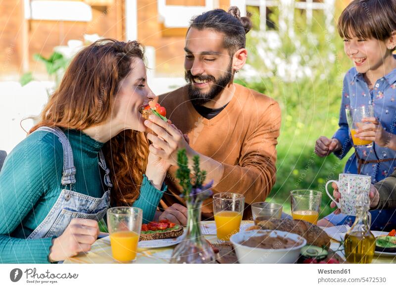 Family enjoying a healthy vegan breakfast in the countryside touristic tourists Bottles Drinking Glass Drinking Glasses dish dishes Plates Tables relax relaxing