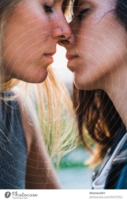 Close-up of affectionate lesbian couple about to kiss twosomes partnership couples Affection Affectionate people persons human being humans human beings kissing