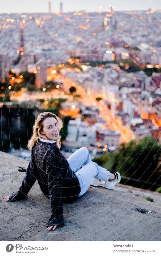Portrait of happy young woman at dawn above the city, Barcelona, Spain human human being human beings humans person persons caucasian appearance