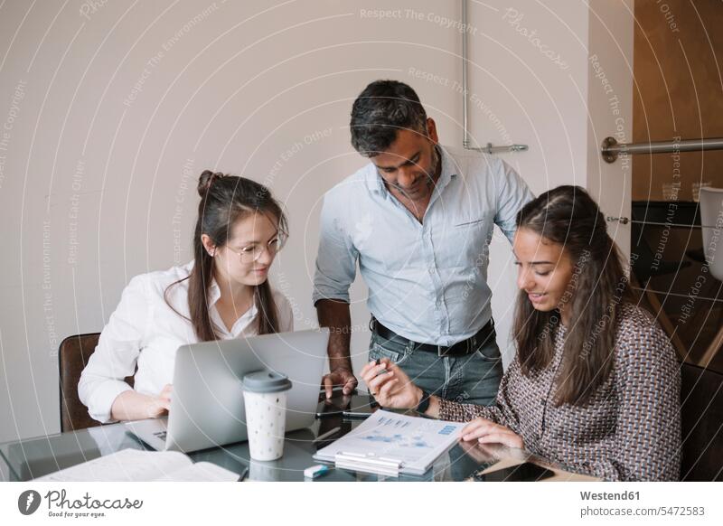 Colleagues working together at table in office colleague Occupation Work job jobs profession professional occupation superior supervisor the boss business life