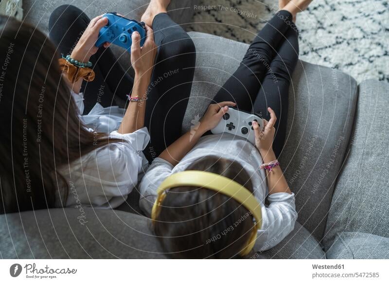Mother and daughter playing video games at home color image colour image indoors indoor shot indoor shots interior interior view Interiors 8-9 years