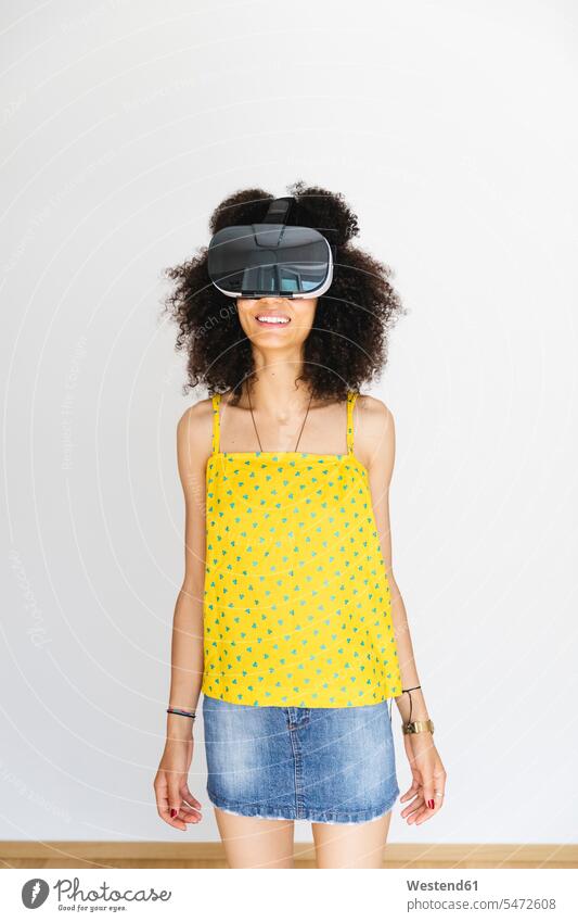 Young woman wearing virtual reality glasses, white background human human being human beings humans person persons North African 1 one person only