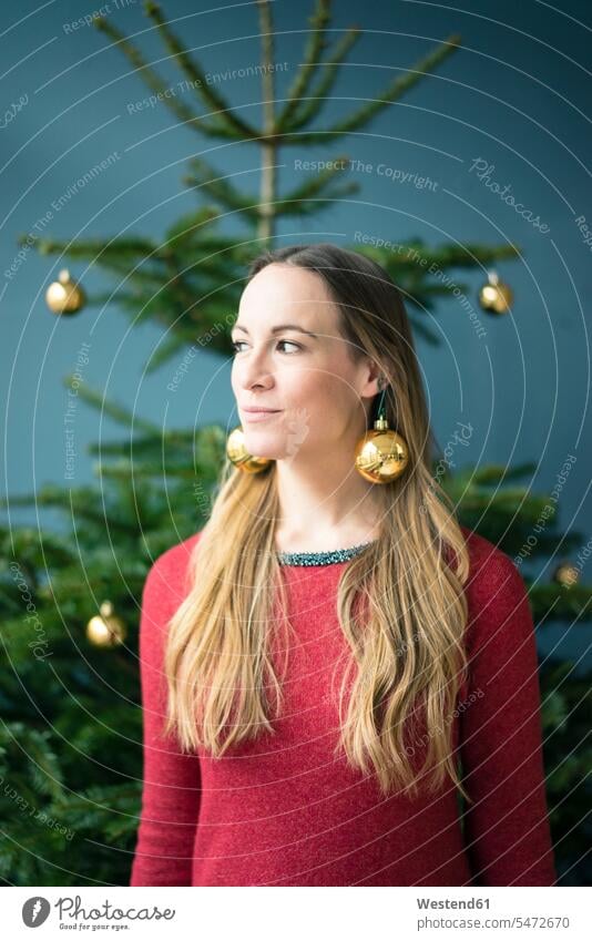 Portrait of woman wearing golden Christmas baubles earrings Earring Earrings Gold Color Gold Colored christmas bauble Christmas tree ball Christmas Ball Bauble
