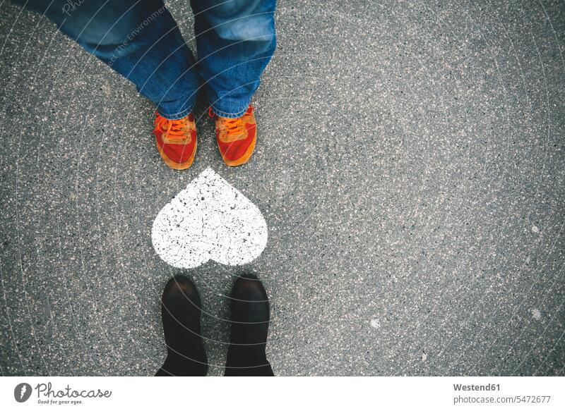 Hungary, Budapest, Feet of man and woman standing by heart on tarmac caucasian caucasian ethnicity caucasian appearance european overhead view directly above