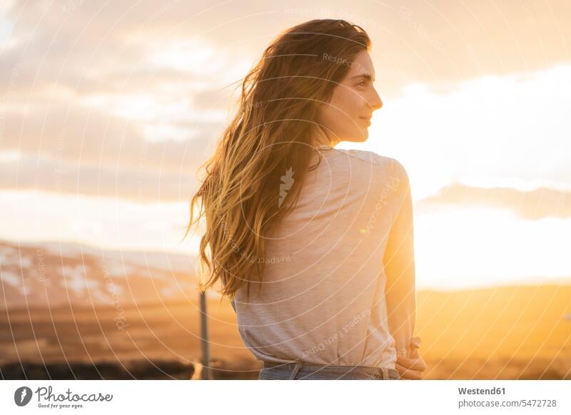 Iceland, young woman at sunset, rear view back view view from the back females women enjoying indulgence enjoyment savoring indulging long hair long-haired
