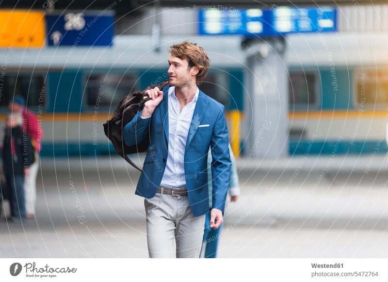 Portrait of young businessman with bag at train station business life business world business person businesspeople Business man Business men Businessmen