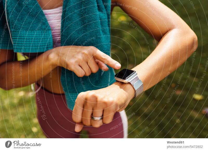 Sporty woman’s arm with smartwatch scrutinizing human human being human beings humans person persons Mixed Race mixed race ethnicity mixed-race Person 1