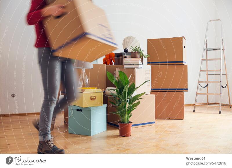Woman carrying cardboard box in a new home human human being human beings humans person persons caucasian appearance caucasian ethnicity european 1