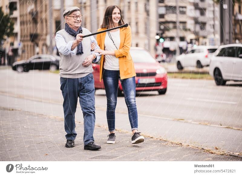 Adult granddaughter assisting her grandfather walking human human being human beings humans person persons caucasian appearance caucasian ethnicity european 2