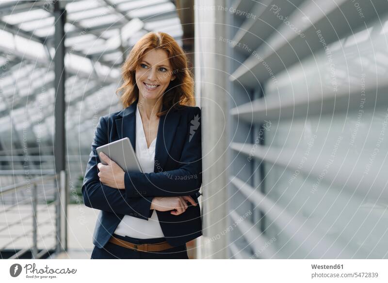 Portrait of a smiling businesswoman holding a tablet in a modern office building Occupation Work job jobs profession professional occupation business life