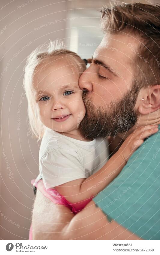 Father kissing his daughter human human being human beings humans person persons braver bravers hero dress hold cuddle snuggle snuggling play embrace