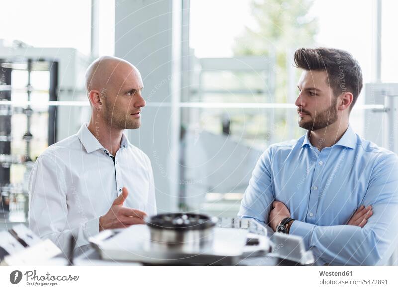Two men discussing product in company products discussion firm business business world business life Doubt Disbelief doubting occupation profession