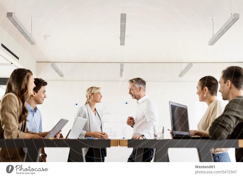 Businesswoman and businessman leading a meeting in office human human being human beings humans person persons caucasian appearance caucasian ethnicity european