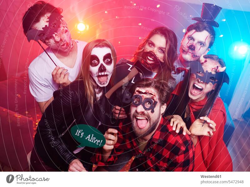 Friends in creepy costumes having fun at Halloween party Party Parties friends hooded All Hallows' Eve celebrating celebrate partying Celebration Celebrations