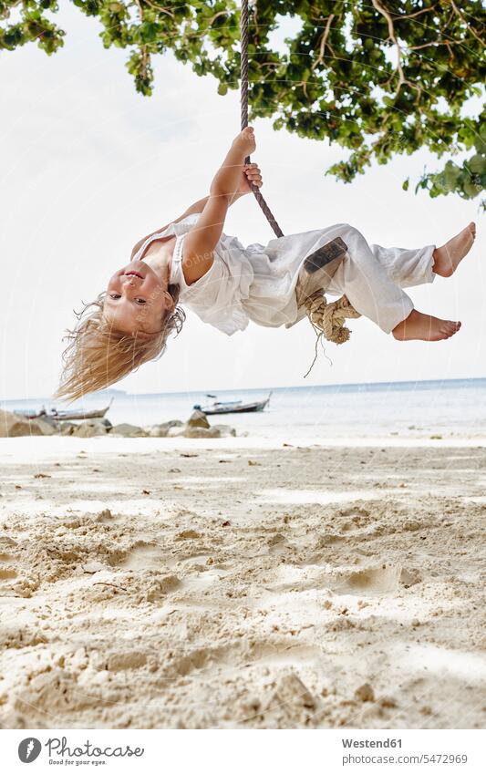 Thailand, Phi Phi Islands, Ko Phi Phi, happy little girl on a rope swing on the beach ropes females girls beaches swinging rock rocking swing set