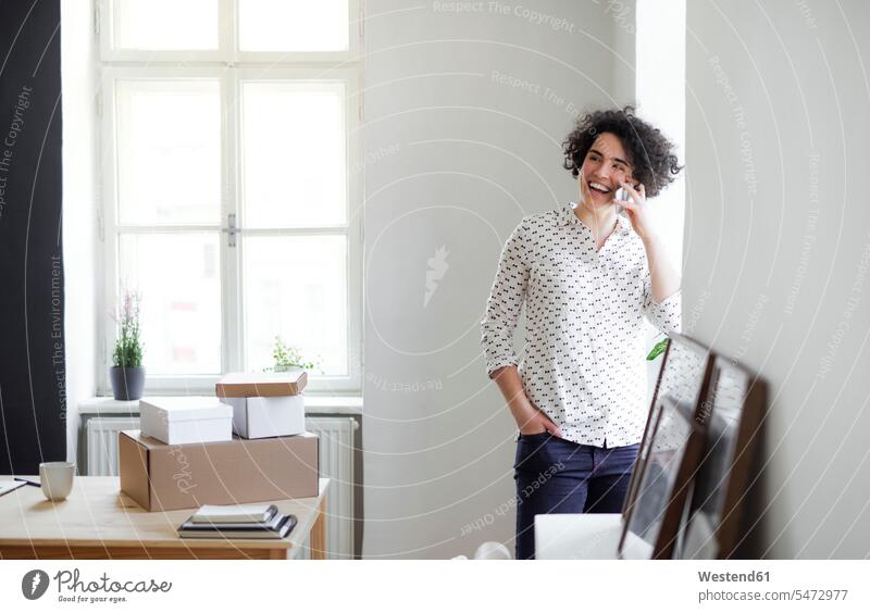 Laughing young woman on the phone in home office Occupation Work job jobs profession professional occupation business life business world business person