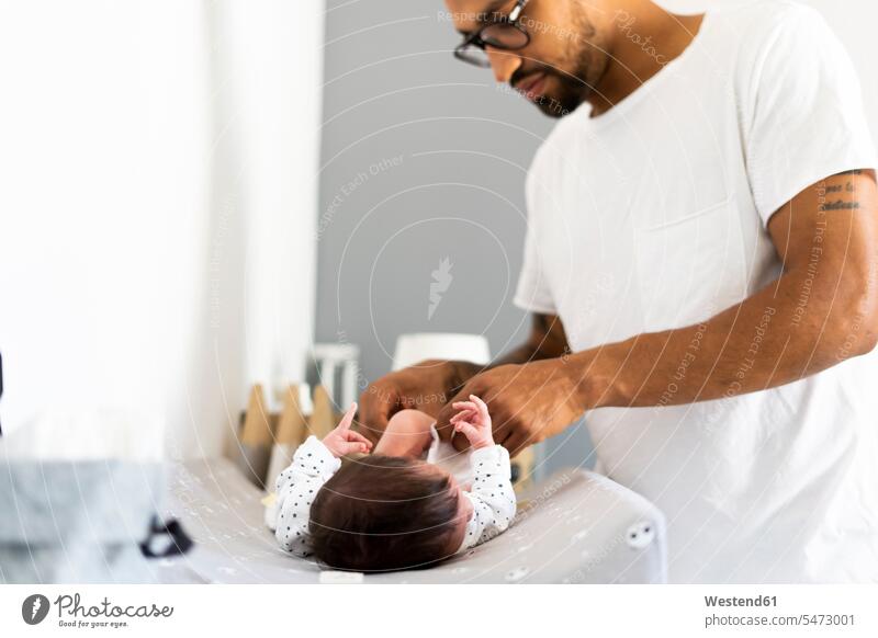 Father changing diaper of his newborn baby African-American Ethnicity Afro-American African American Ethnicity African Americans Afro-Americans white Hygiene