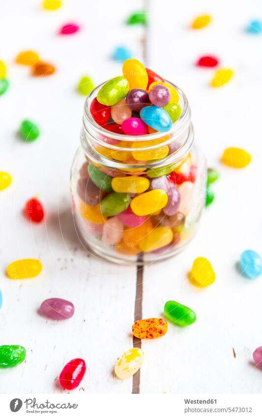 Glass of colourful sweet jellybeans on white wood jelly bean jelly beans nobody diversity abundance abounding colorful copy space Candies Sweetmeats Candy