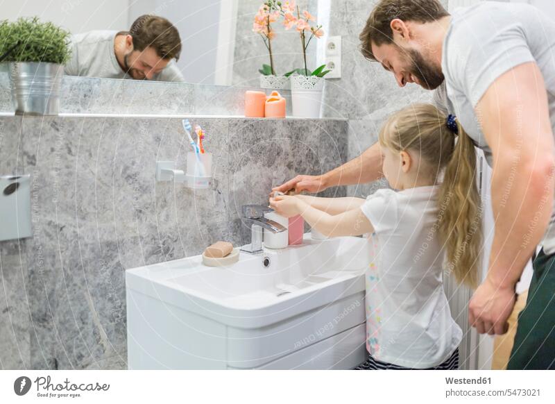 Fahtehr helping his little daughter washing her hands washing hands washing one's hands daughters bath Domestic Bathroom bathroom bath room father pa fathers