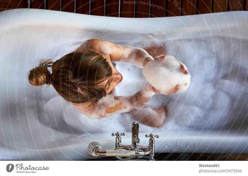 Woman playing with the foam in a bathtub, from above human human being human beings humans person persons caucasian appearance caucasian ethnicity european 1