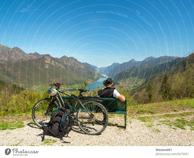 Italy, Lombardy, Senior hiker looking over Idro lake, Adamello Alps, Parco Naturale Adamello Brenta break Looking At View Looking at a view resting wanderers