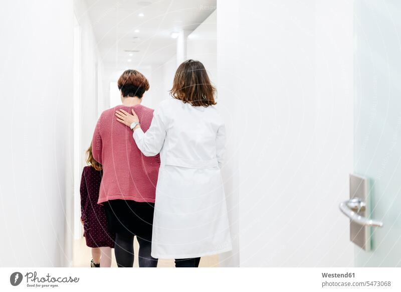 Mother and daughter entering medical practice health healthcare Healthcare And Medicines medicine disease diseases ill illnesses sick Sickness patients