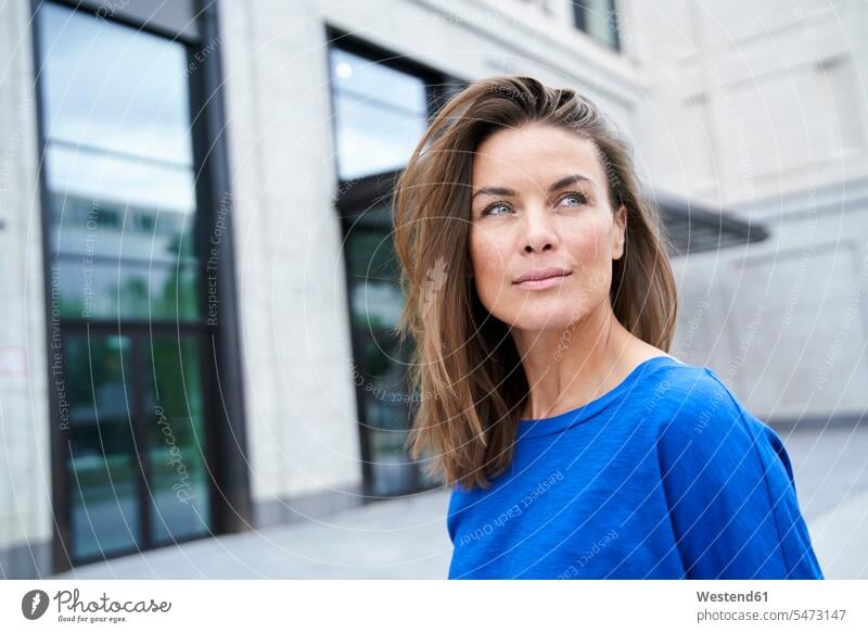 Portrait of attractive brunette woman wearing blue top in the city human human being human beings humans person persons caucasian appearance caucasian ethnicity